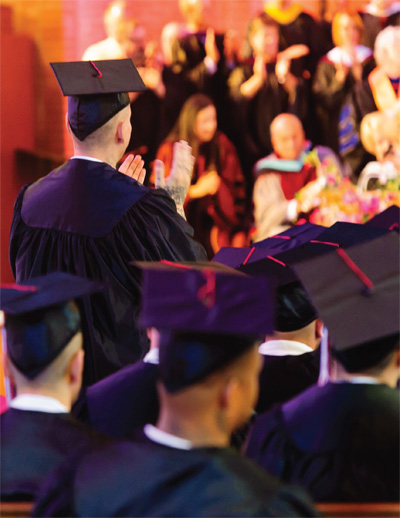 Huntsville Program graduates, educators, and others applaud during a commencement ceremony.