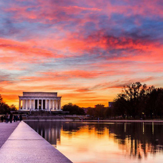 The Lincoln Memorial and reflecting pool with a colorful sunset